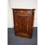 An 18th century oak single door hanging corner cupboard, with frieze drawers, 81cm wide