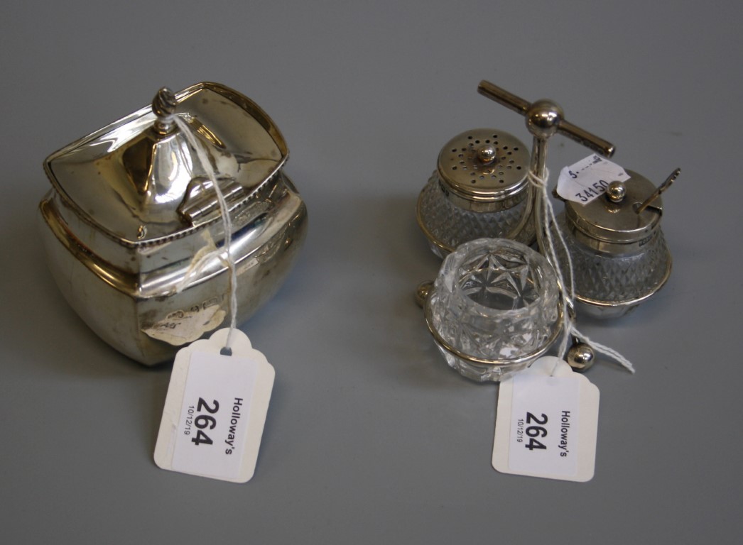 An Edwardian silver three bottle and cut glass cruet stand, in the Christopher Dresser-style,