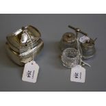 An Edwardian silver three bottle and cut glass cruet stand, in the Christopher Dresser-style,