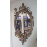 A 19th century carved wood and gilt gesso oval giradole wall mirror with three candle scones, 56cm