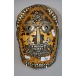 A Tibetan Kapala tortoiseshell mask of the dead with white metal detail, 25cm long