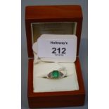 An emerald and diamond three stone half hoop ring, the principal cut-cornered square emerald in