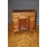 An oak George III style mahogany ladies kneehole writing desk with recessed central cupboard