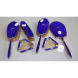 A six piece silver and enamel dressing table set, comprising a hand mirror, a pair of hair