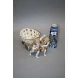 A 19th century Continental porcelain flower chariot drawn by a pair of winged putti, together with a