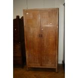 A Heals of Tottenham Court Road limed oak two door compactum wardrobe