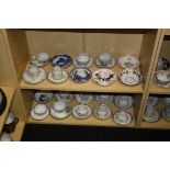 A collection of early 19th century mostly New Hall porcelain, tea bowls and saucers (two shelves)