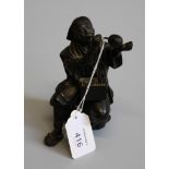 A Japanese Meiji period patinated bronze figure of a man blowing a goose egg, 13cm high