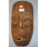 A carved wood African possibly Dan mask with elongated face, 39cm long