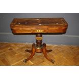 A Regency brass inlaid rosewood foldover card table on 92cm sabre supports
