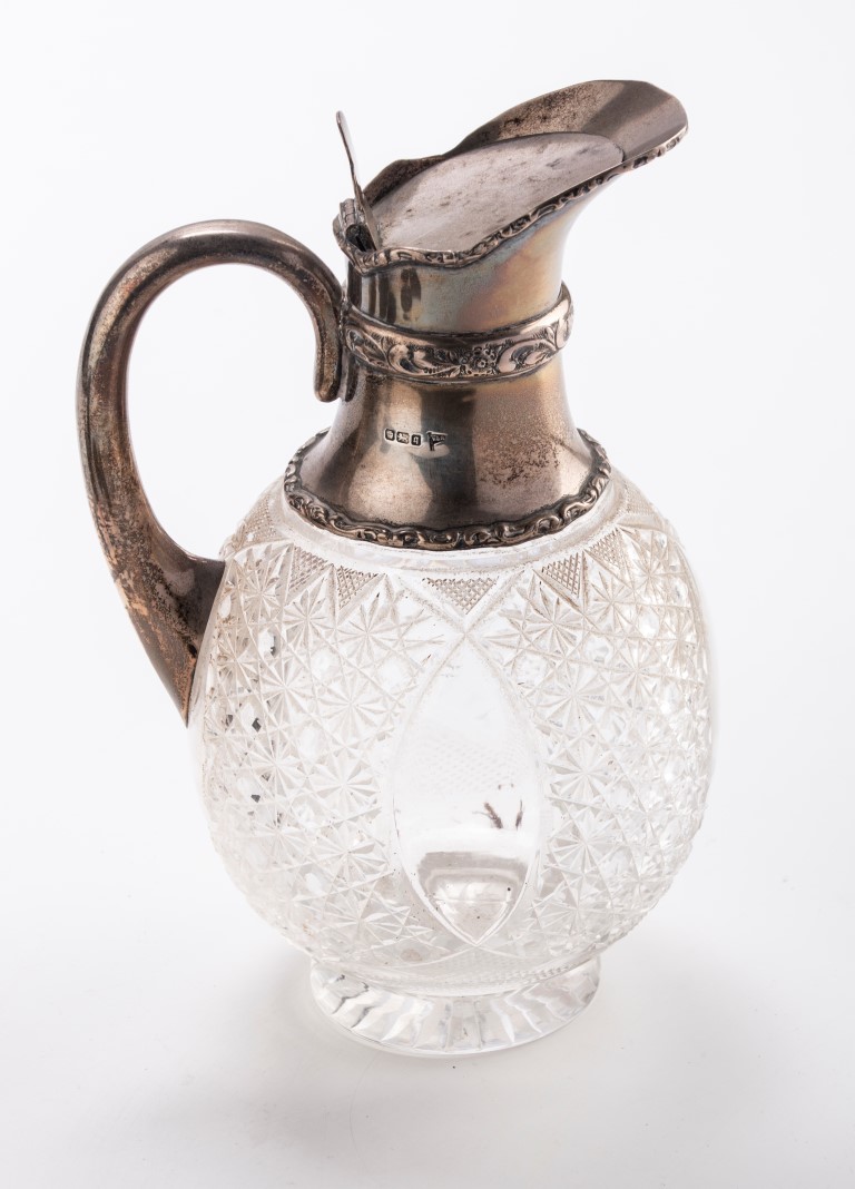 An Edwardian silver mounted claret ewer, hinged cover and looped handle, Sheffield 1908, by Walker