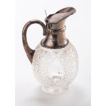 An Edwardian silver mounted claret ewer, hinged cover and looped handle, Sheffield 1908, by Walker