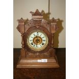 A c1900 walnut cased 8-day mantel clock with porcelain chapter ring