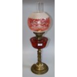 A Victorian cranberry glass pedestal oil lamp with flashed diffuser, 68cm high