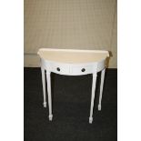 A white painted break bow fronted console table fitted with two drawers on square tapering fluted