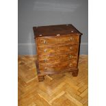 A serpentine fronted George III chest commode, now fitted as a cellarette, 63cm wide