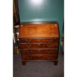 A George III mahogany bureau, the fitted fall over four graduated long drawers with brass