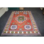 A North West Persian rug woven with central lozenge medallion on a field of guls, within triple