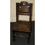 An early 18th century oak regional back stool, with panel back