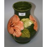 A sage green ground Moorcroft Hibiscus vase, of heavy baluster form, bearing Potters to Queen Mary