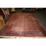 A large machine woven Tekke style carpet of red ground, 299 x 420cm