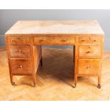A Heals of Tottenham Court Road style light oak kneehole writing desk with moulded caddy top, 121cm