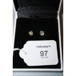 A pair or single stone diamond earrings, the brilliant cut diamonds in four claw mounts, marked 14k,
