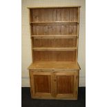 A 19th century stripped pine cupboard base dresser and rack, 100cm wide