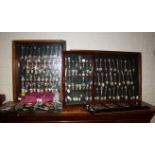 A large collection of mostly EPNS souvenir spoons, some in glazed wall cabinets