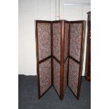 A mahogany three fold room screen with insert fabric panels