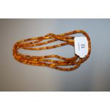 An amber bead longchain, of uniform sized barrel-shaped beads, 212cm, 53.3g Holloway's do not