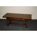 A reproduction 'Long John' heavy oak coffee table, with thick planked top, 122cm long