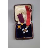 An 18ct gold OBE Knight Grand Cross miniature, together with a silver gilt OBE miniature