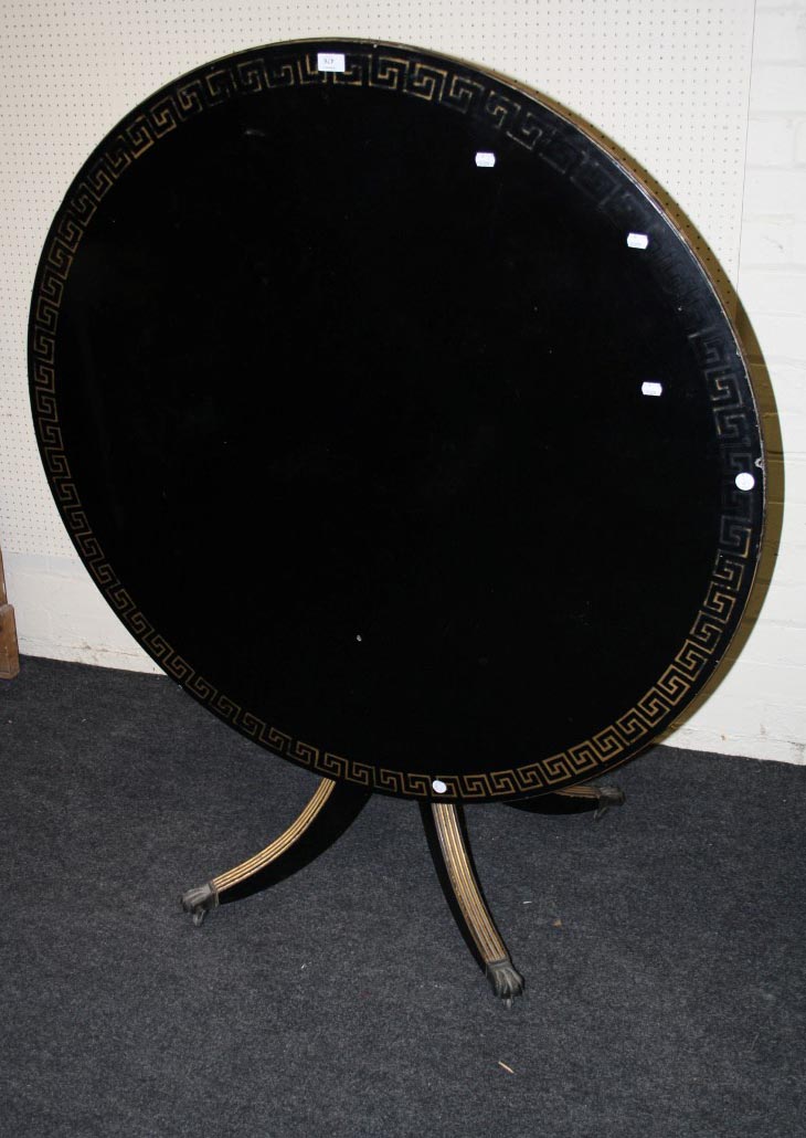 An Ebonized Regency style circular centre table with gilt engraved detail, 119cm