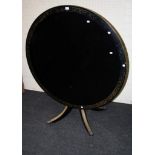 An Ebonized Regency style circular centre table with gilt engraved detail, 119cm