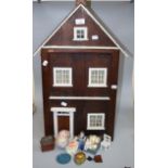 A 1930s folk art wooden two room dolls house, with painted detail containing many period