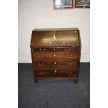 A George III oak fall front writing bureau, with inlaid and fitted interior, 93cm wide