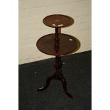 A reproduction mahogany wine table with two dished tiers on a wrythen knop column three downswept