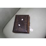 A Victorian leather musical photograph album with single cylinder and comb movement, 30 x 23cm