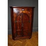 A George III mahogany two door corner cupboard with shaped doors, 97cm wide