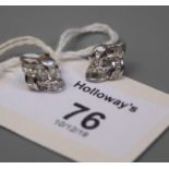 A pair of lozenge shaped diamond knot earrings, set with baguette and single cut diamonds