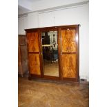 An Edwardian mirror door three section gentleman's mahogany wardrobe,198cm wide