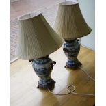 A pair of contemporary table lamps, each fashioned as a gilt metal mounted blue and white Chinese