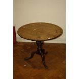 A George III oak circular snap top wine table with vase stem and tripod base, 83cm diameter