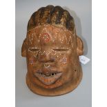 A carved wood and beaded African 'Makonde' helmet mask with painted hair, 24cm high