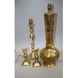 A large pierced brass table lamp, together with another brass lamp and a pair of brass table