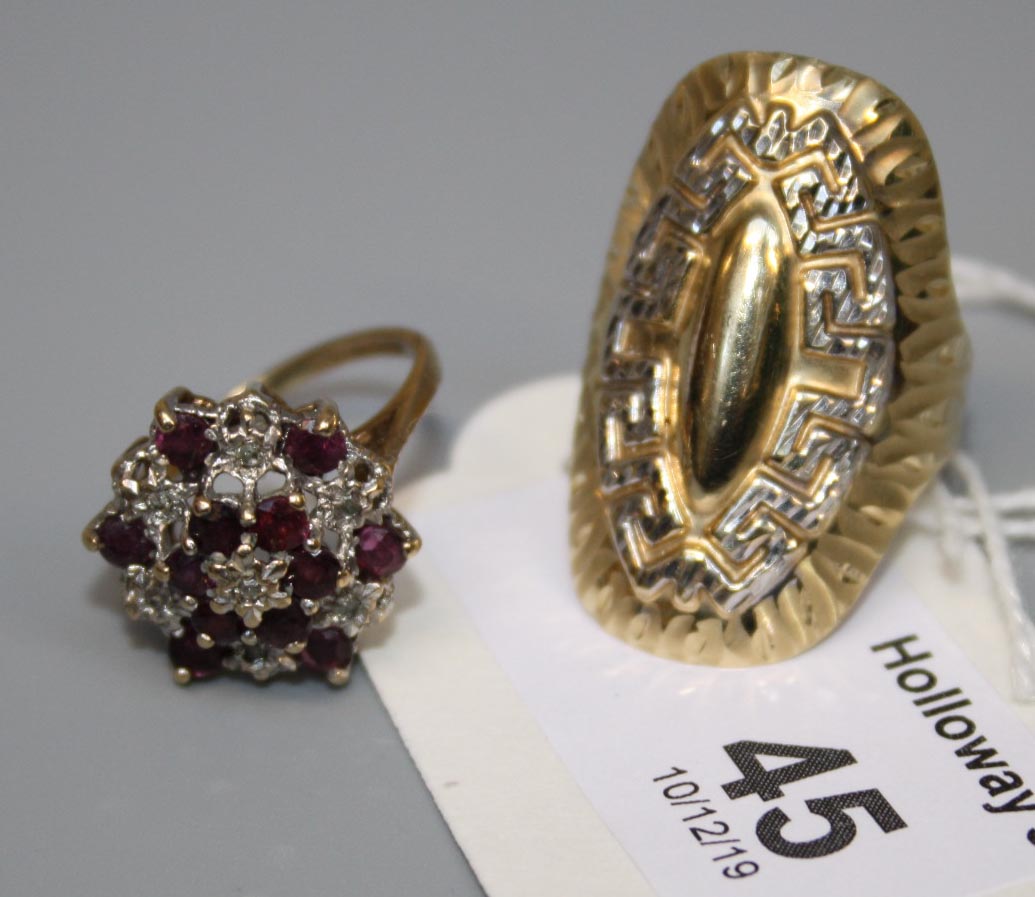 A 14ct gold dress ring, oval with embossed Greek key design, and a ruby and diamond cluster ring,