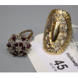 A 14ct gold dress ring, oval with embossed Greek key design, and a ruby and diamond cluster ring,