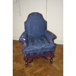 A Queen Anne-style scroll arm upholstered chair, with periwig feet