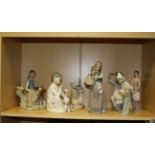 Seven Lladro figures/ groups including girl with calf, recumbent fawn, child with hand mirror,